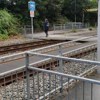 Go through the metal barriers, cross the tram lines via the tarmac walkway with care, and turn right to pass between more metal barriers.
