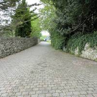 Head past the schools to the left as the lane becomes a paved footpath.
