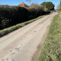 Keep following the road.  You may have to step up on the verge to let cars pass.