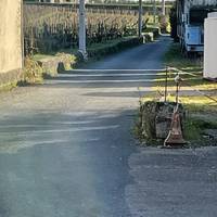 Here’s a view of the lane as you turn right. A large hangar on the right, vineyards on the left.