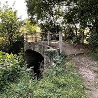 Cross the stone bridge over the Wellow Brook.