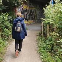 The path curves slightly to the left to pass under a railway bridge.