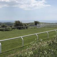 You walk alongside the race track for a while. Head towards the sea! 