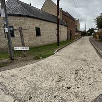 As The Street curves left, continue straight onto Mill Lane.