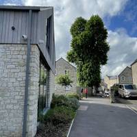 With your back to Hope House, turn left along the tarmac footpath and go past the black bollards.