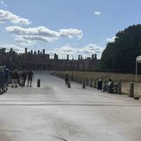 Exit the bus and walk to the entrance to Hampton Court. It’s busy with tourists. Cross the road and head over the bridge.