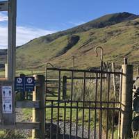 Go through the gate onto the footpath towards the lake.  The signs remind you that this is sheep country, so dogs on lead for the next bit!