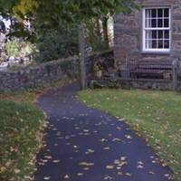 The riverside path goes to the left of a pretty row of cottages