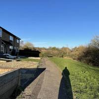 Where the road ends, continue in the same direction of travel on the tarmac footpath in front of the last few houses.