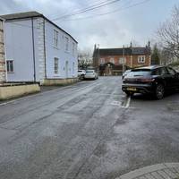 Towards the end of the road there is no pavement so carefully make your way through the car parking area.