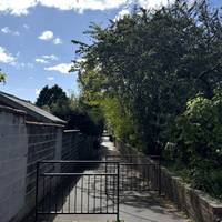 Turn right, through this barrier and continue down Barnes Passage.