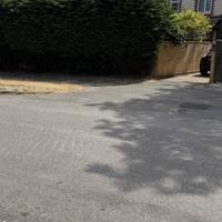 Turn to face the lay-by and cross using the dropped kerb to join the pavement alongside the houses.