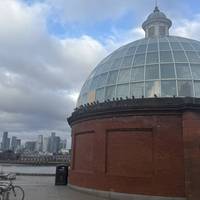 The foot tunnel entrances can be seen either side of the river. Here we have views of Canary Wharf. Head into the tunnel entrance.