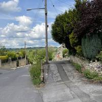 Keep right and head up the small access road and walk past the terraced housing.