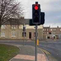 Stop at the first set of traffic lights on the right. We need to use our stop, look and listen skills before crossing the busy road.