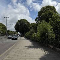 Turn away from the bus stop, so that the road is to your left. Walk along the pavement.