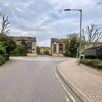 Go right into Stonewood Road at the brick roundabout. Walk down the road.