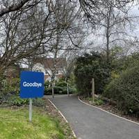 Continue on the tarmac footpath, passing through metal bollards and bearing slight right.