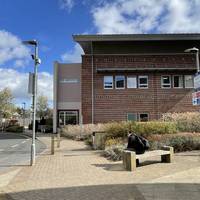 With your back to the entrance of the Nuffield Orthopaedic Centre, head right past a bench. There is a cafe and accessible toilets here.