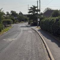 Continue down the residential road straight ahead.
