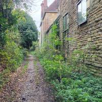 Head past the buildings.