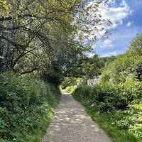 Walk with the river on your right on the wide compacted path. There may be some loose small rocks.