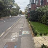Continue on the pavement for a short time. There are some interesting homes on the left side and a creek passes under the road.