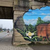 Walk up to the main road (A240) and take a right at the deer mural.