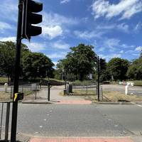 Turn left to use the crossing and head over the road towards the leisure centre.