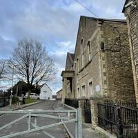 Pass through a pedestrian area in front of Vallis First School.