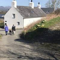 The narrow lane opposite the car parking zigzags up past these cottages towards the headland
