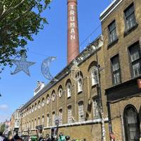 With your back towards Brick Lane Yard, turn right. Walk past 93 Feet East and continue until the next right.
