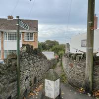 Cross the road at the pedestrian crossing then turn down this footpath right opposite the bus stop.