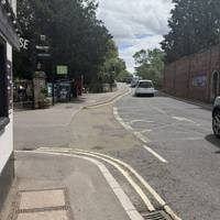 Just before the bridge is Castle Lane. Turn left between the two pubs.