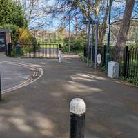 As the path emerges onto Charnock Avenue continue past the bollards.