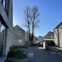 With your back to Hope House, turn left along the tarmac footpath and go past the black bollards.