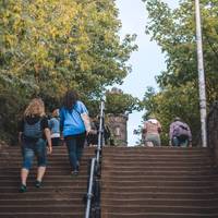 After the first flight take the first right and take the longer flight of stairs up to Calton Hill