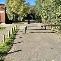 Pass a barrier and keep ahead to the right of the Lido.