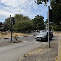 As you reach the traffic lights, follow the pavement around to the right.