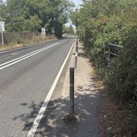 There’s a bus stop on the south side of the river where it’s safe for taxis to stop. Head up the pavement on the right towards the bridge.