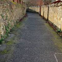Continue along the walled alleyway