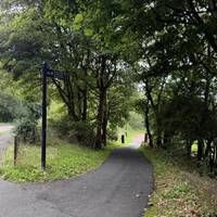 Turn right down a sloped pathway to enter the park and get ready to turn right.