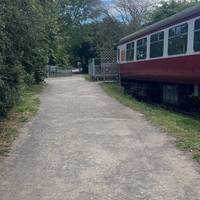 Continue past the railway carriage