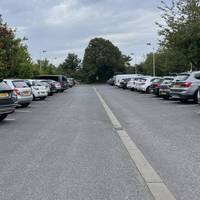 Turn left into car park and walk to the far end, be aware of moving vehicles. At the end of the car park exit right.