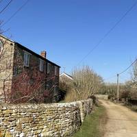 Follow the road as it bends to the left.