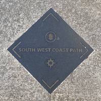 At the end of the path turn left and follow the South West Coast Path sign. This road is Great Eastern Road.