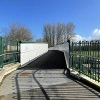 Head over the bridge which crosses the railway tracks and Marsh Barton railway station. The bridge & shared path have a hard, flat surface.