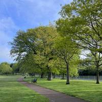 When you’re ready, follow the tarmac path as it curves around towards the left. There are beautiful trees on your right hand side & benches.