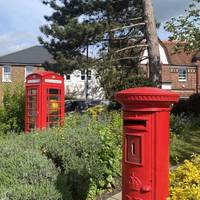 At the end of the approach, there is a lovely small garden on the right with a traditional Post Box and Telephone Box.