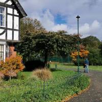 Take the path that curves left past the black and white building, now used as a nursery.